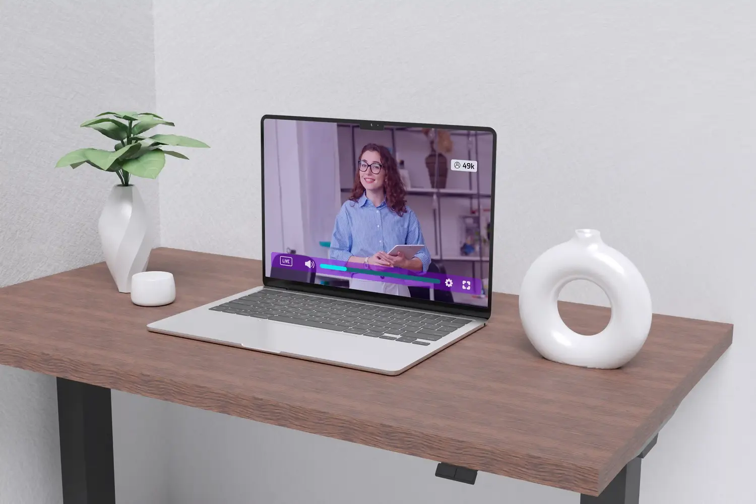 A laptop with a hosted video playing where a woman is providing a staff briefing.