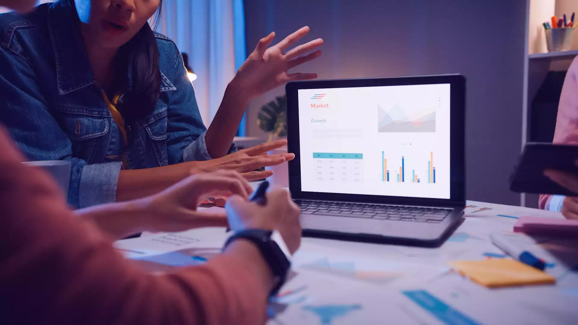 Two people are looking at SEO and site performance graphs and are trying to understand how their hosted videos have impacted the site.