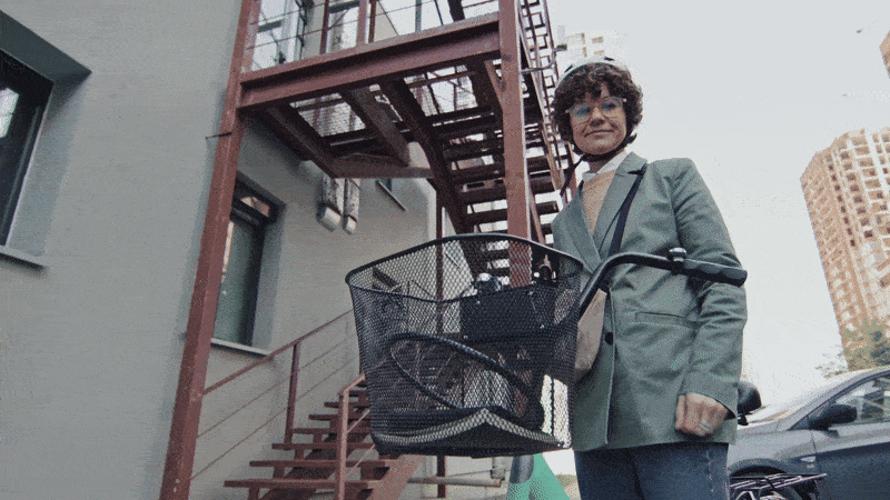 Low-angle shot of a person standing beside a bicycle, filmed from below to emphasise height and confidence, illustrating how this camera angle adds power and perspective in video storytelling hosted on Cinema8.